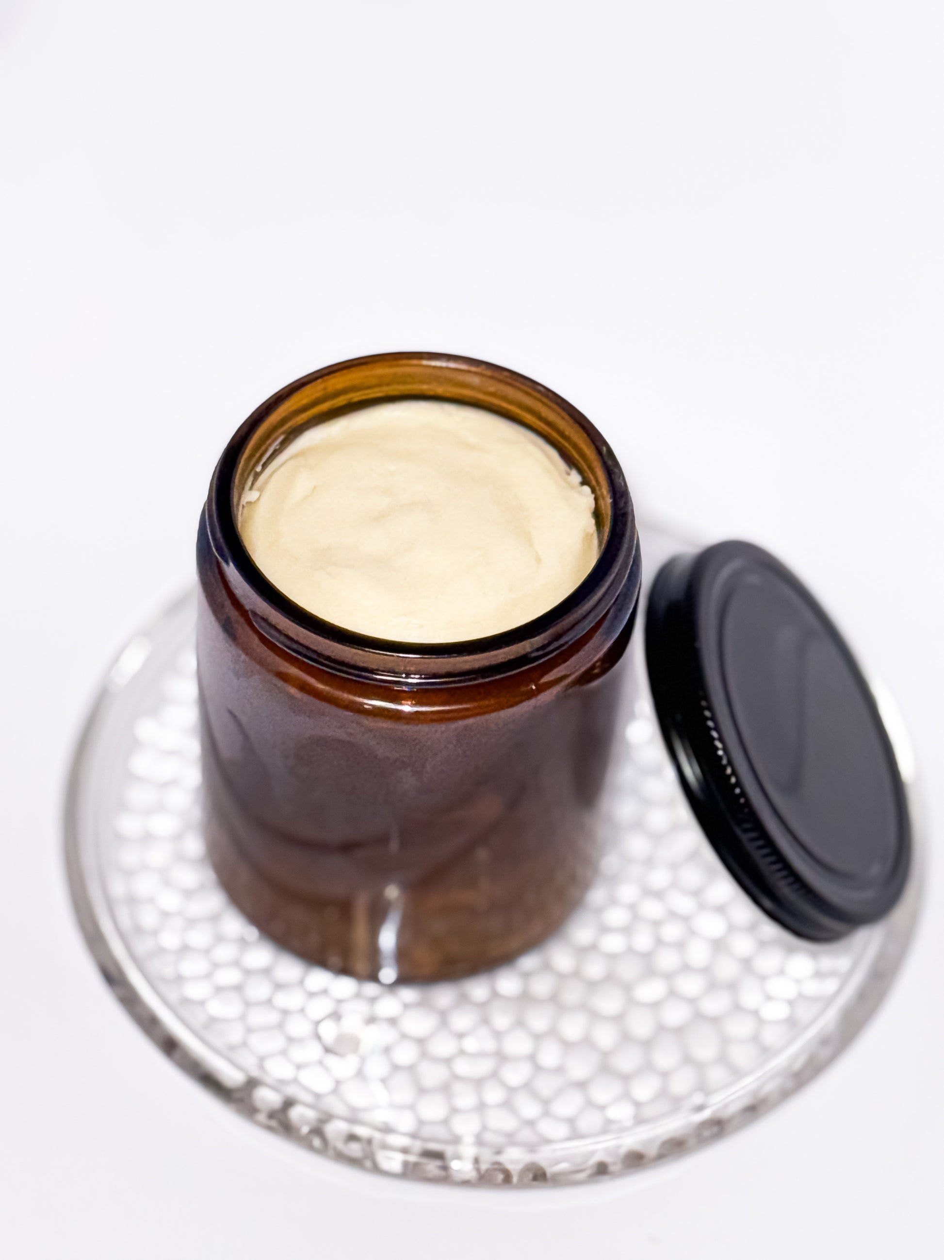 Large amber glass jars filled with Aurora Vita Co.’s unscented whipped body butter. Luxurious, all-natural skincare in eco-friendly packaging.